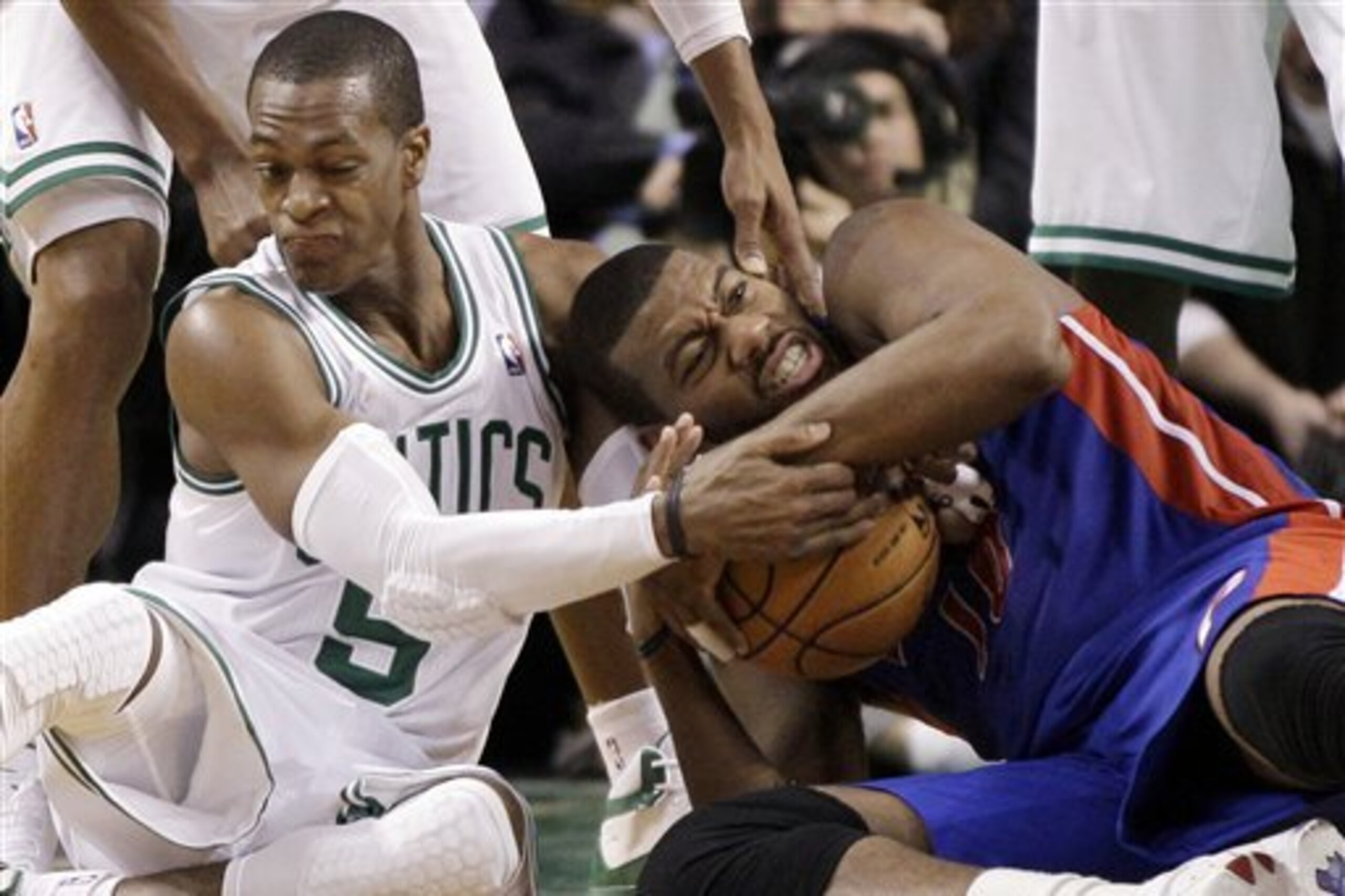 Detroit Pistons center Greg Monroe, right, fights for control of the ball against Boston Celtics guard Rajon Rondo (9) in the second half of an NBA basketball game in Boston, Wednesday, Feb. 15, 2012. The Pistons won 98-88. (AP Photo/Elise Amendola)