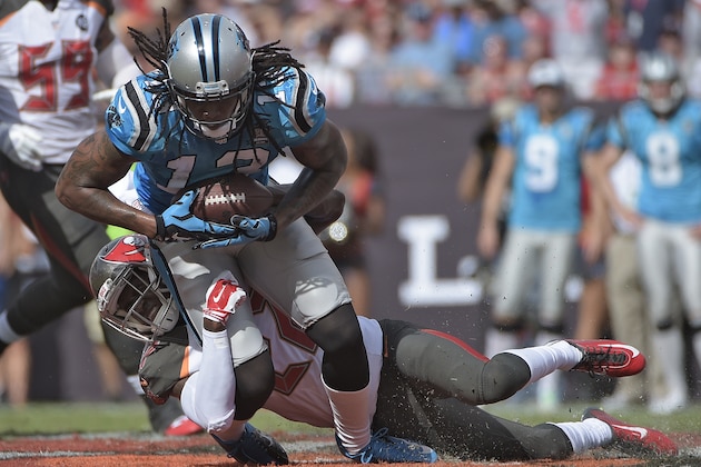 Carolina Panthers wide receiver Kelvin Benjamin (13) is brought down by Tampa Bay Buccaneers cornerback Johnthan Banks (27) during the first quarter of an NFL football game Sunday, Sept. 7, 2014, in Tampa, Fla. (AP Photo/Phelan M. Ebenhack)