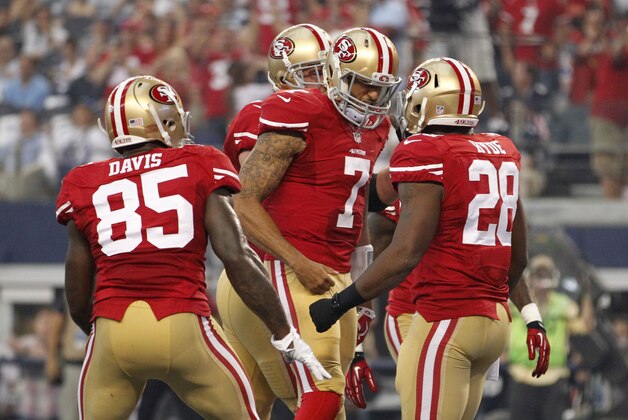 Sep 7, 2014; Arlington, TX, USA;San Francisco 49ers tight end Vernon Davis (85) and quarterback Colin Kaepernick (7) celebrate with running back Carlos Hyde (28)  after he scored a touchdown in the second quarter at AT&T Stadium. Mandatory Credit: Tim Heitman-USA TODAY Sports