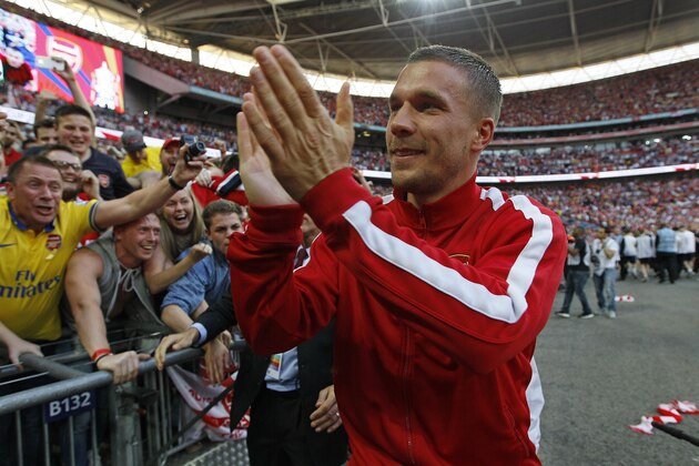 Arsenal's Lukas Podolski celebrates after winning the English FA Cup final soccer match between Arsenal and Hull City at Wembley Stadium in London, Saturday, May 17, 2014. Arsenal won 3-2 after extra-time. (AP Photo/Kirsty Wigglesworth)