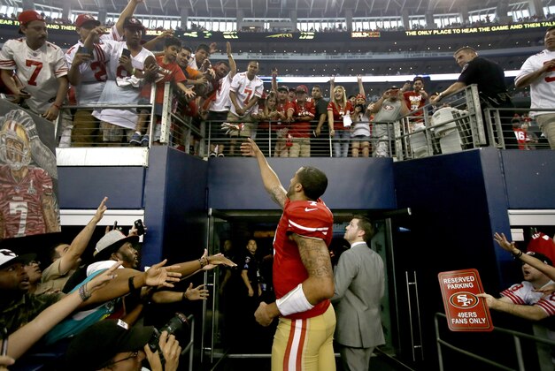 San Francisco 49ers quarterback Colin Kaepernick (7) interacts with fans after their 28-17 win over the Dallas Cowboys in an NFL football game, Sunday, Sept. 7, 2014, in Arlington, Texas. (AP Photo/Tony Gutierrez)