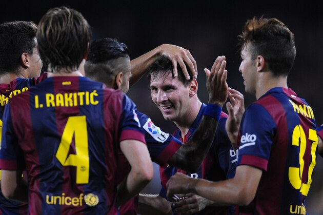 FC Barcelona's Lionel Messi from Argentina, second right, reacts after scoring against Elche during a Spanish La Liga soccer match at the Camp Nou stadium in Barcelona, Spain, Sunday, Aug. 24, 2014. (AP Photo/Manu Fernandez)