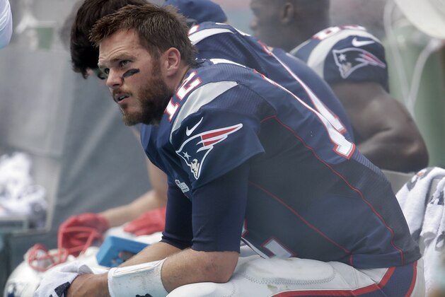 New England Patriots quarterback Tom Brady (12) sits on the sidelines during the first half of an NFL football game, in Miami Gardens, Fla., Sunday Sept. 7, 2014. The Dolphins defeated the Patriots 33-20.  (AP Photo/Lynne Sladky)