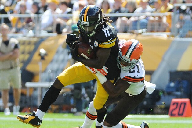 Cleveland Browns cornerback Justin Gilbert (21) tackles Pittsburgh Steelers wide receiver Markus Wheaton (11) during the second quarter of an NFL football game on Sunday, Sept. 7, 2014, in Pittsburgh. Pittsburgh won 30-27.(AP Photo/Don Wright)