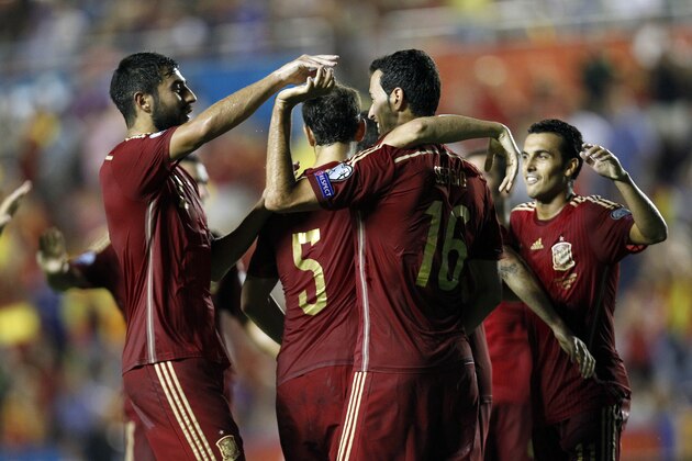 Spain player's Sergio Busquets, second right, is congratulated by teammate after scoring a goal against Macedonia during a Euro 2016 Group C qualifying round soccer match, at Ciutat de Valencia stadium, in Valencia, Spain, on Monday, Sept. 8, 2014. (AP Photo/Alberto Saiz)
