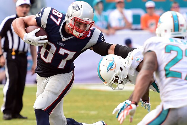 Sep 7, 2014; Miami Gardens, FL, USA;  New England Patriots tight end Rob Gronkowski (87) is tackled by Miami Dolphins cornerback Jamar Taylor (22) in the second half at Sun Life Stadium. Miami won 33-20.  Mandatory Credit: Brad Barr-USA TODAY Sports