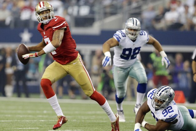 San Francisco 49ers quarterback Colin Kaepernick (7) rolls out and throws a touchdown against the Dallas Cowboys first half of an NFL football game, Sunday, Sept. 7, 2014, in Arlington, Texas. (AP Photo/LM Otero)