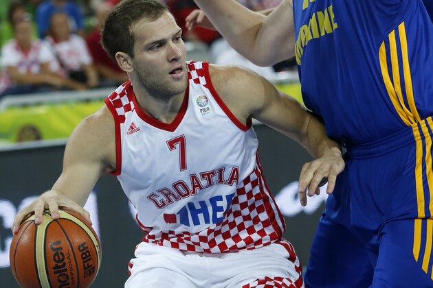 Ukraine's Kyryl Natyazhko, right, tries to stop Croatia's Bojan Bogdanovic, left, during their EuroBasket European Basketball Championship quarterfinal match in Ljubljana, Slovenia, Thursday, Sept. 19, 2013. (AP Photo/Petr David Josek)