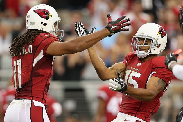 GLENDALE, AZ - AUGUST 24:  Wide receivers Larry Fitzgerald #11 and Michael Floyd #15 of the Arizona Cardinals celerbate during the preseason NFL game against the Cincinnati Bengals against the Cincinnati Bengals at the University of Phoenix Stadium on August 24, 2014 in Glendale, Arizona. The Bengals defeated the Cardinals 19-13.  (Photo by Christian Petersen/Getty Images)