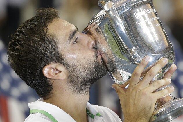 Marin Cilic, of Croatia, kisses the championship trophy after defeating Kei Nishikori, of Japan, in the championship match of the 2014 U.S. Open tennis tournament, Monday, Sept. 8, 2014, in New York. (AP Photo/Darron Cummings)