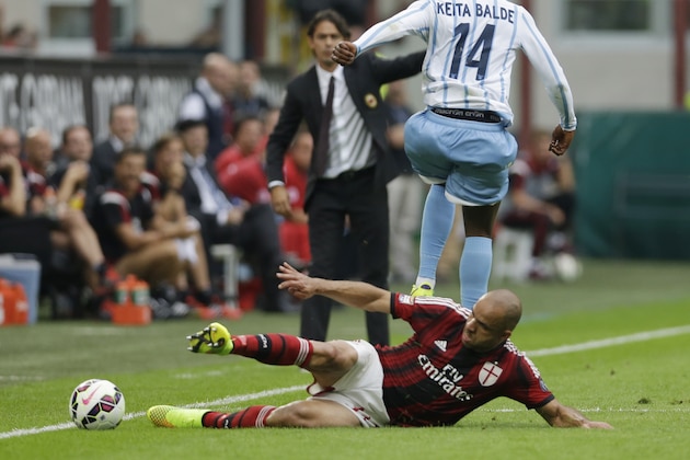 Lazio forward Balde Diao Keita, left, is tackled by AC Milan's Alex, during a Serie A soccer match between AC Milan and Lazio, at the San Siro stadium in Milan, Italy, Sunday, Aug. 31, 2014. (AP Photo/Luca Bruno)