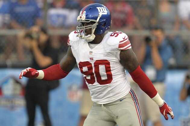 New York Giants defensive end Jason Pierre-Paul (90) blocks against the Buffalo Bills during the Pro Football Hall of Fame exhibition NFL football game Sunday, Aug. 3, 2014, in Canton, Ohio. New York won 17-13. (AP Photo/David Richard)