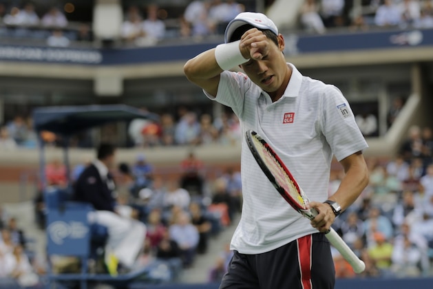 Kei Nishikori, of Japan, walks back to the baseline during his match against Marin Cilic, of Croatia, during the championship match of the 2014 U.S. Open tennis tournament, Monday, Sept. 8, 2014, in New York. (AP Photo/Charles Krupa)