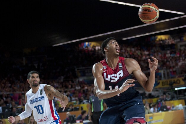 Anthony Davis of the US, right, tries to control the ball in front as Dominican Republic's James Feldeine during the Group C Basketball World Cup match, in Bilbao northern Spain, Wednesday, Sept. 3, 2014. The 2014 Basketball World Cup competition take place in various cities in Spain from Aug. 30 to Sept. 14. (AP Photo/Alvaro Barrientos)