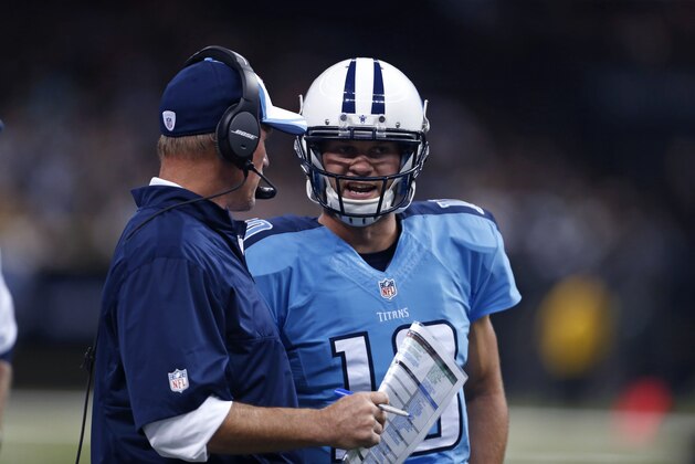 Tennessee Titans quarterback Jake Locker (10) talks to  head coach Ken Whisenhuntin the first half of an NFL preseason football game in New Orleans, Friday, Aug. 15, 2014. (AP Photo/Rogelio Solis)