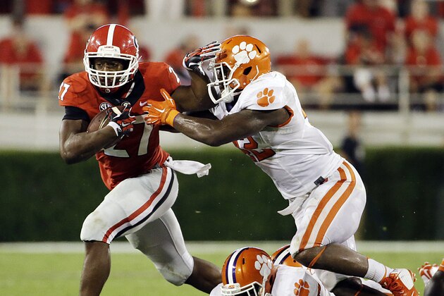 Georgia's Nick Chubb, left, breaks free from the tackle of Clemson's Stephone Anthony, to run for a touchdown in the second half of an NCAA college football game, Saturday, Aug. 30, 2014, in Athens, Ga. (AP Photo/David Goldman)
