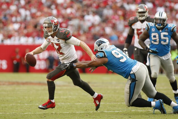 Tampa Bay Buccaneers quarterback Josh McCown (12) evades Carolina Panthers defensive tackle Dwan Edwards (92) during an NFL football game on Sunday, Sept. 7, 2014, in Tampa, Fla. (AP Photo/Brian Blanco)