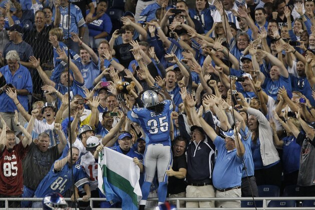 Detroit Lions running back Joique Bell (35) celebrates his touchdown during the fourth quarter of an NFL football game against the New York Giants with fans in Detroit, Monday, Sept. 8, 2014. (AP Photo/Duane Burleson)