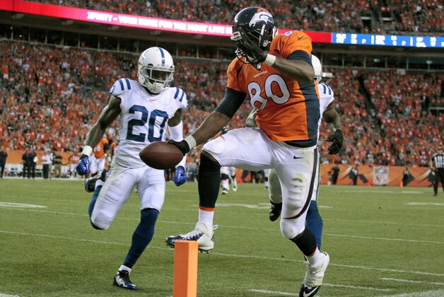 Denver Broncos tight end Julius Thomas (80) scores as Indianapolis Colts free safety Darius Butler (20) approaches during the first half of an NFL football game, Sunday, Sept. 7, 2014, in Denver. (AP Photo/Joe Mahoney) Denver Broncos tight end Julius Thomas (80) scores as Indianapolis Colts free safety Darius Butler (20) approaches during the first half of an NFL football game, Sunday, Sept. 7, 2014, in Denver. (AP Photo/Joe Mahoney)