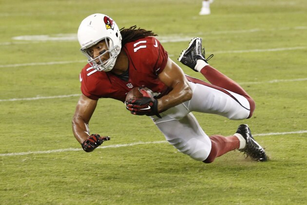 Arizona Cardinals wide receiver Larry Fitzgerald (11) makes a catch against the San Diego Chargers during the second half of an NFL football game, Monday, Sept. 8, 2014, in Glendale, Ariz. (AP Photo/Ross D. Franklin)