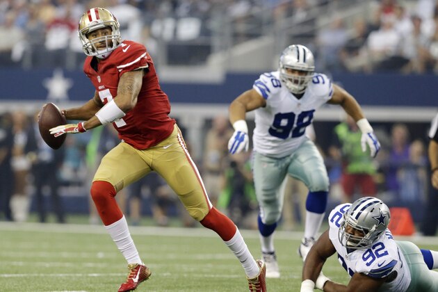 San Francisco 49ers quarterback Colin Kaepernick (7) rolls out and throws a touchdown against the Dallas Cowboys first half of an NFL football game, Sunday, Sept. 7, 2014, in Arlington, Texas. (AP Photo/LM Otero)