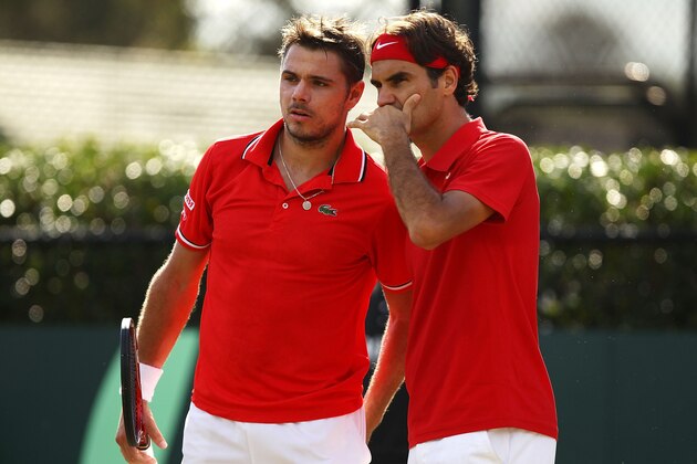 SYDNEY, AUSTRALIA - SEPTEMBER 17:  Roger Federer (R) of Switzerland speaks to Stanislas Wawrinka (L) during their Davis Cup World Group Playoff Tie match against Lleyton Hewitt and Chris Guccione of Australia at Royal Sydney Golf Club on September 17, 2011 in Sydney, Australia.  (Photo by Matt King/Getty Images)