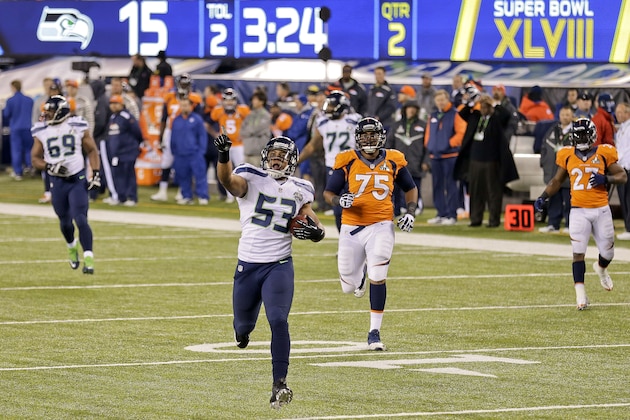 Seattle Seahawks outside linebacker Malcolm Smith (53) reacts as he returns an interception for a touchdown against the Denver Broncos during the first half of the NFL Super Bowl XLVIII football game, Sunday, Feb. 2, 2014, in East Rutherford, N.J. (AP Photo/Gregory Bull) Seattle Seahawks outside linebacker Malcolm Smith (53) reacts as he returns an interception for a touchdown against the Denver Broncos during the first half of the NFL Super Bowl XLVIII football game, Sunday, Feb. 2, 2014, in East Rutherford, N.J. (AP Photo/Gregory Bull)