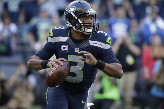Seattle Seahawks quarterback Russell Wilson looks to pass in the first half of an NFL football game against the Green Bay Packers, Thursday, Sept. 4, 2014, in Seattle. (AP Photo/Elaine Thompson)