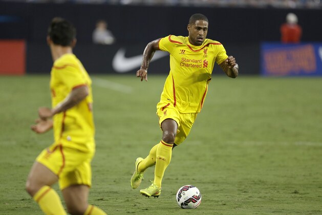 Liverpool's Glen Johnson (2) moves the ball against AC Milan during a Guinness International Champions Cup soccer match in Charlotte, N.C., Saturday, Aug. 2, 2014. Liverpool won 2-0. (AP Photo/Bob Leverone)