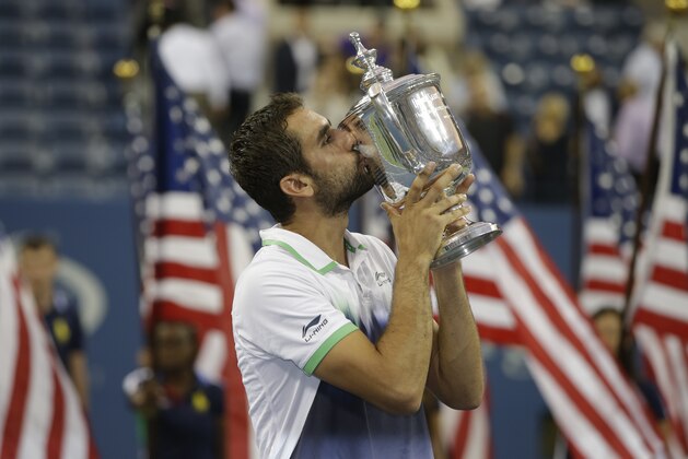 Marin Cilic, of Croatia, kisses the championship trophy after defeating Kei Nishikori, of Japan, in the championship match of the 2014 U.S. Open tennis tournament, Monday, Sept. 8, 2014, in New York. (AP Photo/Darron Cummings)