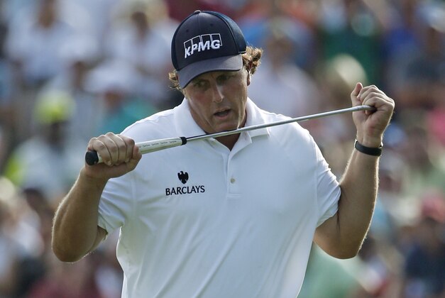 Phil Mickelson reacts to his missed eagle putt on the 18th hole during the third round of the PGA Championship golf tournament at Valhalla Golf Club on Saturday, Aug. 9, 2014, in Louisville, Ky. (AP Photo/Mike Groll)
