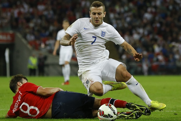 England's Jack Wilshere, right, collides with Norway's Havard Nordtveit during the international friendly soccer match between England and Norway at Wembley Stadium in London, Wednesday, Sept. 3, 2014. (AP Photo/Kirsty Wigglesworth)