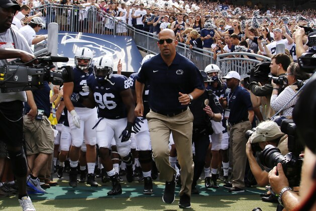Penn State head coach James Franklin, center, leads his team onto the field at Beaver Stadium before an NCAA college football game against Akron in State College, Pa., Saturday, Sept. 6, 2014. Penn State won 21-3. (AP Photo/Gene J. Puskar)