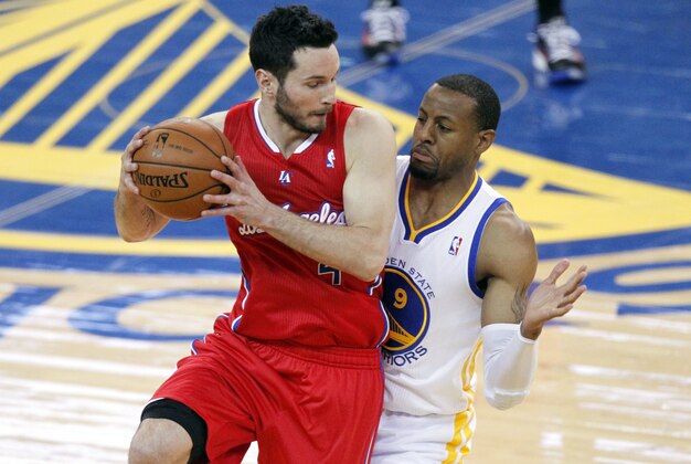May 1, 2014; Oakland, CA, USA; Los Angeles Clippers guard J.J. Redick (4) looks to pass the ball away from the reach of Golden State Warriors forward Andre Iguodala (9) during the first quarter in game six of the first round of the 2014 NBA Playoffs at Oracle Arena. Mandatory Credit: Cary Edmondson-USA TODAY Sports