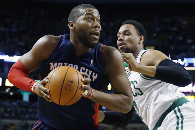 Detroit Pistons' Greg Monroe, left, looks to shoot past Boston Celtics' Jared Sullinger, right, in the first quarter of an NBA basketball game in Boston, Sunday, March 9, 2014. (AP Photo/Michael Dwyer)
