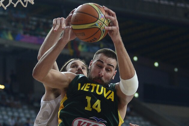 New Zealand's Casey Frank, rear, vies for the ball with Lithuania's Jonas Valanciunas during their Basketball World Cup Round of 16 match at the Palau Sant Jordi in Barcelona, Spain, Sunday, Sept. 7, 2014. The 2014 Basketball World Cup competition will take place in various cities in Spain from Aug. 30 through to Sept. 14. (AP Photo/Manu Fernandez)