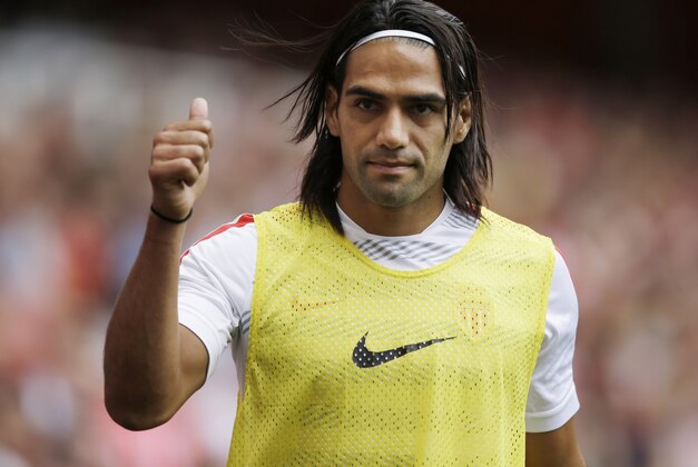 FILE - This is a Saturday, Aug. 2, 2014  file photo of AS Monaco player Radamel Falcao  as he gives a thumbs up to fans as he warms up on the sideline during the second half of the Emirates Cup soccer match between AS Monaco and Valencia at Arsenal's Emirates Stadium in London.  Radamel Falcao is set to join Manchester United on loan after the Premier League club agreed to a loan deal with Monaco, a person with knowledge of the deal said Monday Sept. 1, 2014.  (AP Photo/Matt Dunham, File)