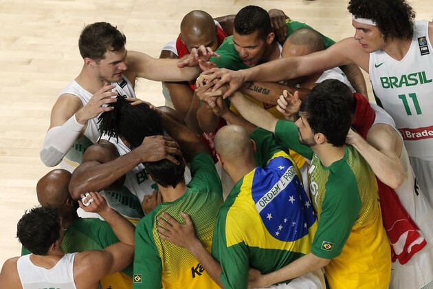 Brazil's players celebrate after defeating Argentina during the World Cup Round of 16 match between Brazil and Argentina in Madrid, Spain, Sunday, Sept. 7, 2014 . The 2014 Basketball World Cup competition will take place in various cities in Spain from Aug. 30 through to Sept. 14. (AP Photo/Daniel Ochoa de Olza)