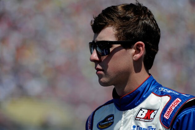 BROOKLYN, MI - AUGUST 16:  Ryan Blaney, driver of the #29 Cooper Standard Careers for Vets Ford, stands on the grid prior to the NASCAR Camping World Truck Series Careers For Veterans 200 at Michigan International Speedway on August 16, 2014 in Brooklyn, Michigan.  (Photo by Jared C. Tilton/Getty Images)