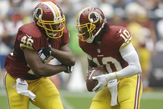 Washington Redskins' Robert Griffin III (10) looks to hand off to Alfred Morris (46) during the first quarter of an NFL football game against the Houston Texans, Texans, Sunday, Sept. 7, 2014, in Houston. (AP Photo/Patric Schneider)