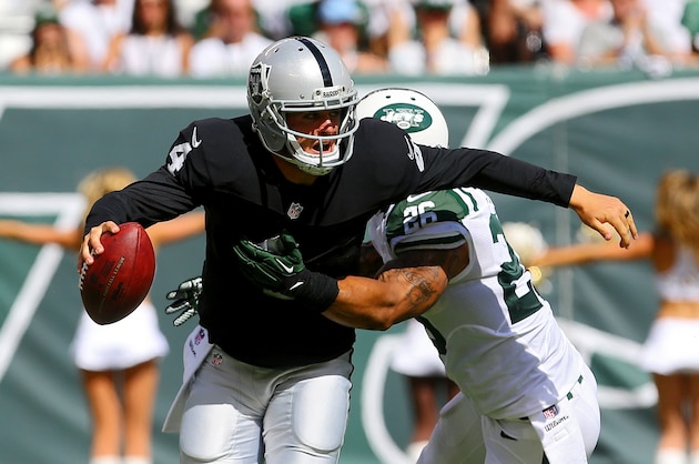 EAST RUTHERFORD, NJ - SEPTEMBER 07:  Dawan Landry #26 and Jason Babin #58 of the New York Jets sack Derek Carr #4 of the Oakland Raiders during the third quarter at MetLife Stadium on September 7, 2014 in East Rutherford, New Jersey.  (Photo by Ed Mulholland/Getty Images)