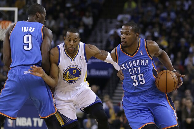 Oklahoma City Thunder's Kevin Durant, right, drives the ball around Golden State Warriors' Andre Iguodala, center, as Serge Ibaka sets a pick during the first half of an NBA basketball game Thursday, Nov. 14, 2013, in Oakland, Calif. (AP Photo/Ben Margot)