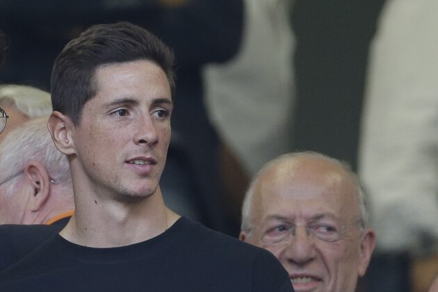 AC Milan forward Fernando Torres of Spain watches from the stands during a Serie A soccer match between AC Milan and Lazio, at the San Siro stadium in Milan, Italy, Sunday, Aug. 31, 2014. (AP Photo/Luca Bruno)