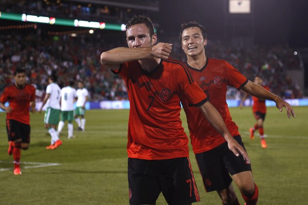 Mexico defenseman Miguel Layun, front, celebrates his goal as forward Erick Torres follows against Bolivia in the first half of an international friendly soccer game in Commerce City, Colo., on Tuesday, Sept. 9, 2014. (AP Photo/David Zalubowski)