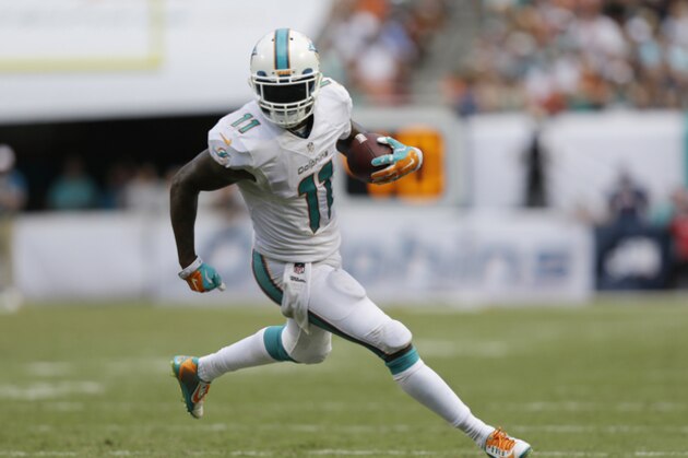 Miami Dolphins wide receiver Mike Wallace (11) runs for a touchdown during the second half of an NFL football game against the New England Patriots, in Miami Gardens, Fla., Sunday Sept. 7, 2014. (AP Photo/Wilfredo Lee)