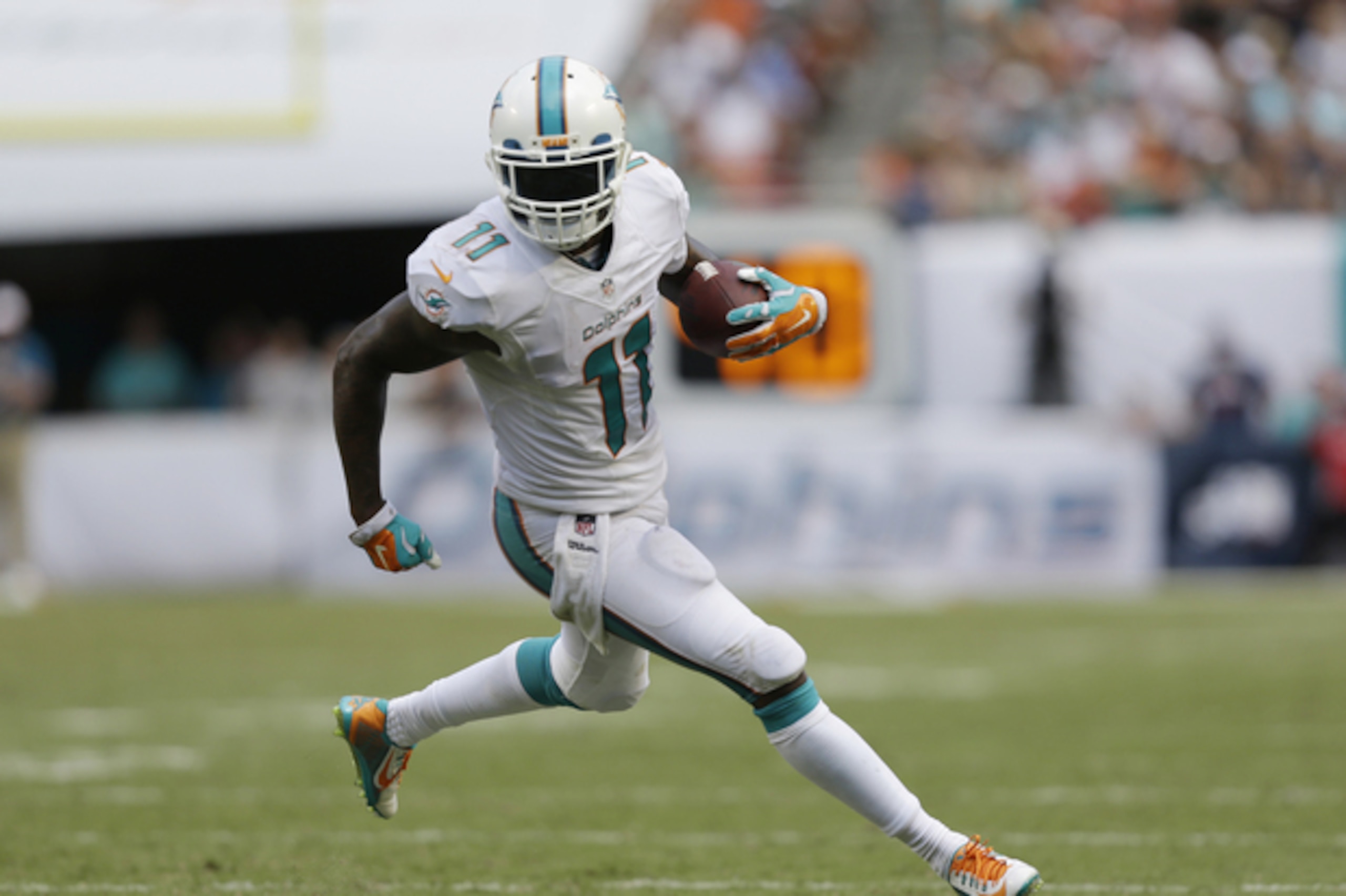 Miami Dolphins wide receiver Mike Wallace (11) runs for a touchdown during the second half of an NFL football game against the New England Patriots, in Miami Gardens, Fla., Sunday Sept. 7, 2014. (AP Photo/Wilfredo Lee)