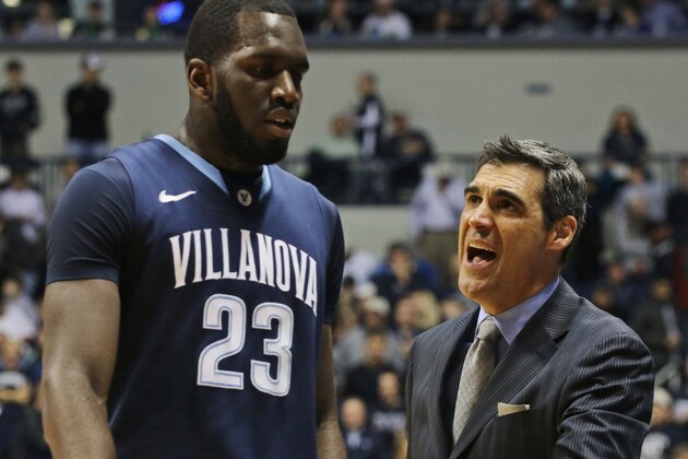 Villanova coach Jay Wright talks with Daniel Ochefu during the first half of an NCAA college basketball game against Xavier in Cincinnati on Thursday, March 6, 2014. (AP Photo/Tom Uhlman)