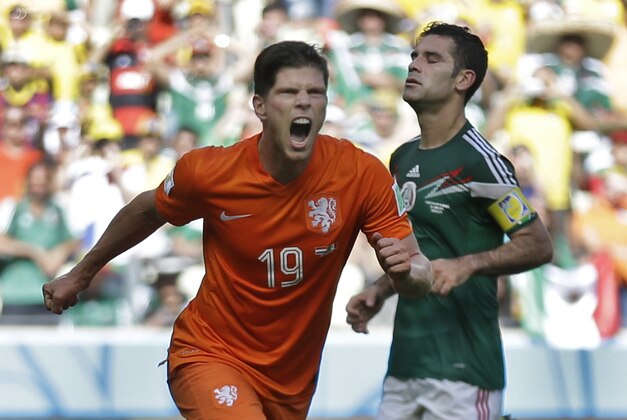 Netherlands' Klaas-Jan Huntelaar celebrates after scoring his side's second goal during the World Cup round of 16 soccer match between the Netherlands and Mexico at the Arena Castelao in Fortaleza, Brazil, Sunday, June 29, 2014.  The Netherlands won the match 2-1. (AP Photo/Natacha Pisarenko)