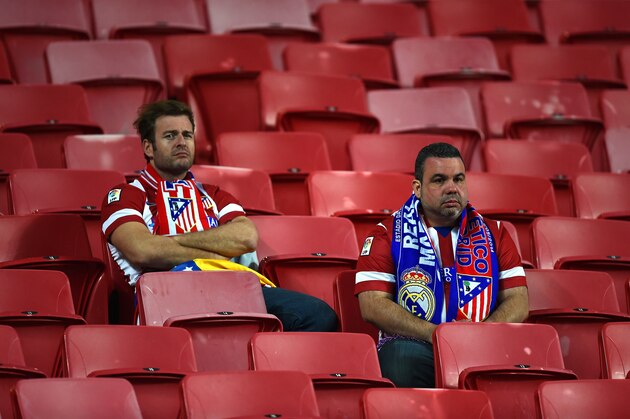 LISBON, PORTUGAL - MAY 24:  Dejected Atletico de Madrid fans look on after defeat in the UEFA Champions League Final between Real Madrid and Atletico de Madrid at Estadio da Luz on May 24, 2014 in Lisbon, Portugal.  (Photo by Laurence Griffiths/Getty Images)