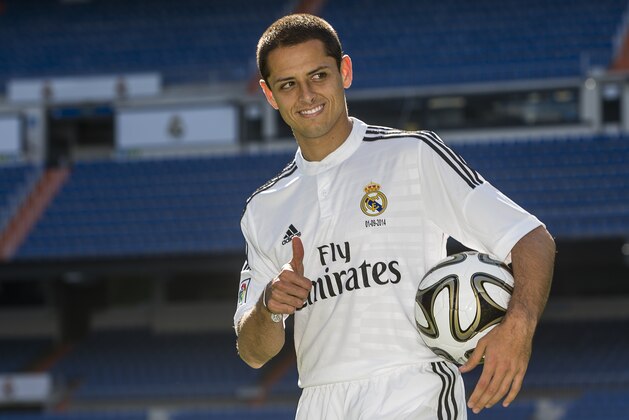 Mexico's international soccer player Javier Hernandez 'Chicharito', poses during his official presentation at the Santiago Bernabeu stadium in Madrid, Spain, Monday, Sept. 1, 2014, after signing for Real Madrid. (AP Photo/Andres Kudacki)
